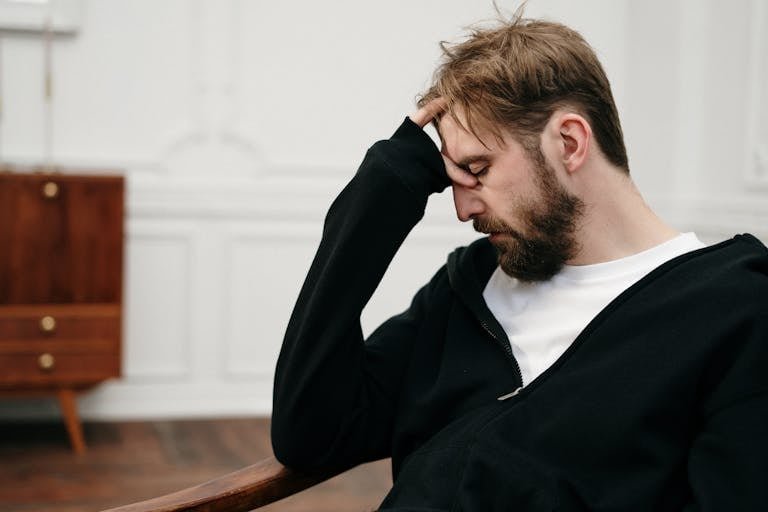 Man in Black Blazer Sitting on Chair